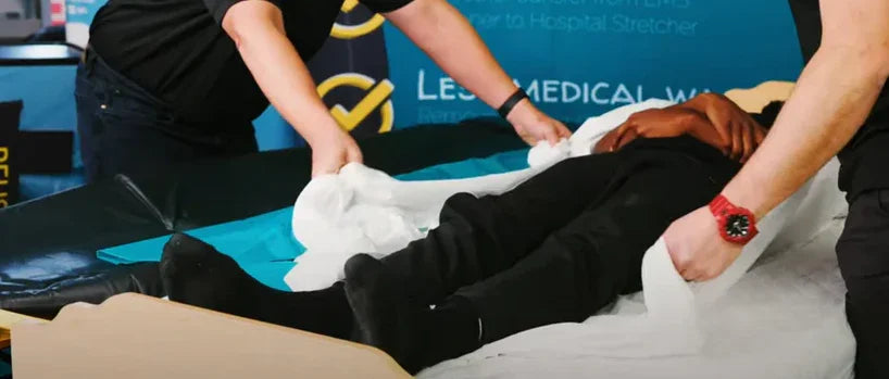 Two paramedics lifting a patient using Badger Skin M1 reusable patient slider