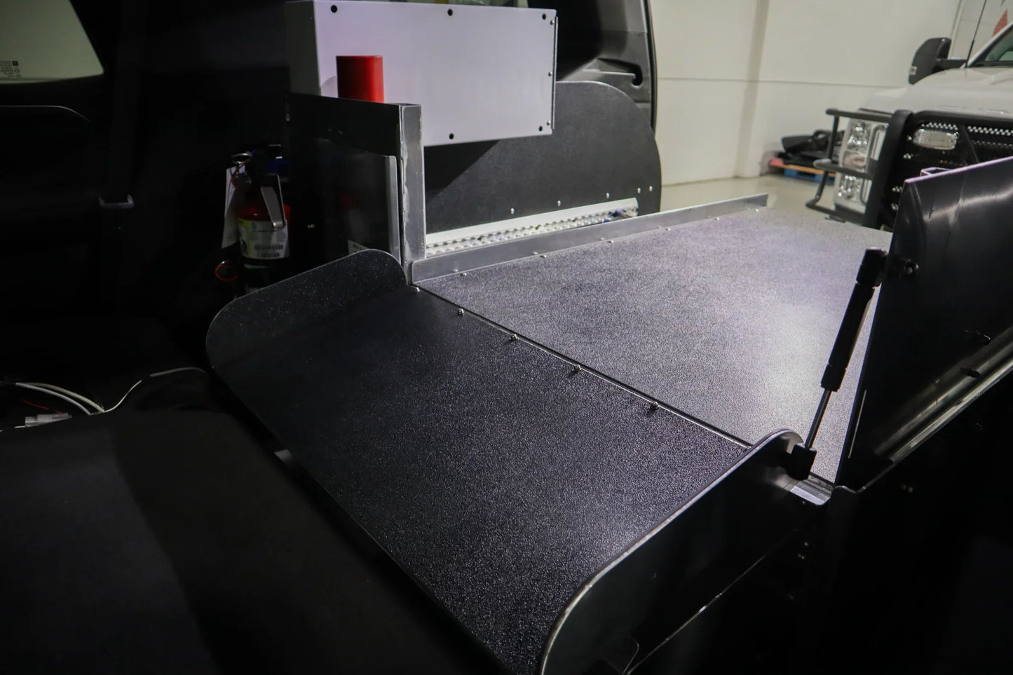 Foldable insert in Chevrolet Tahoe rear cargo storage for emergency response use.