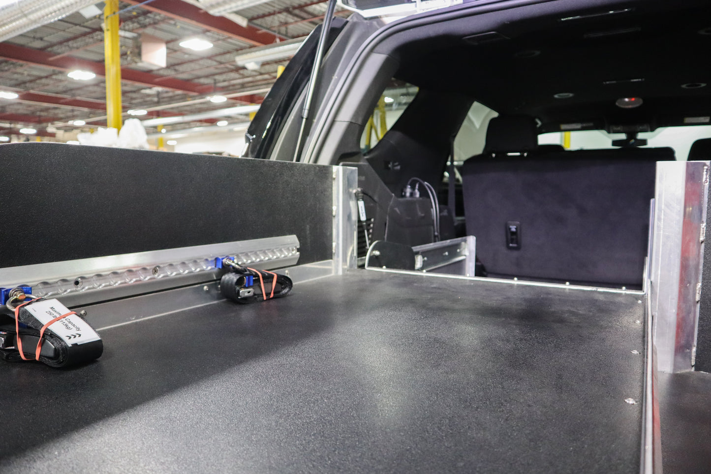 Rear storage system in a Chevrolet Tahoe emergency vehicle with fold-able stretcher insert.