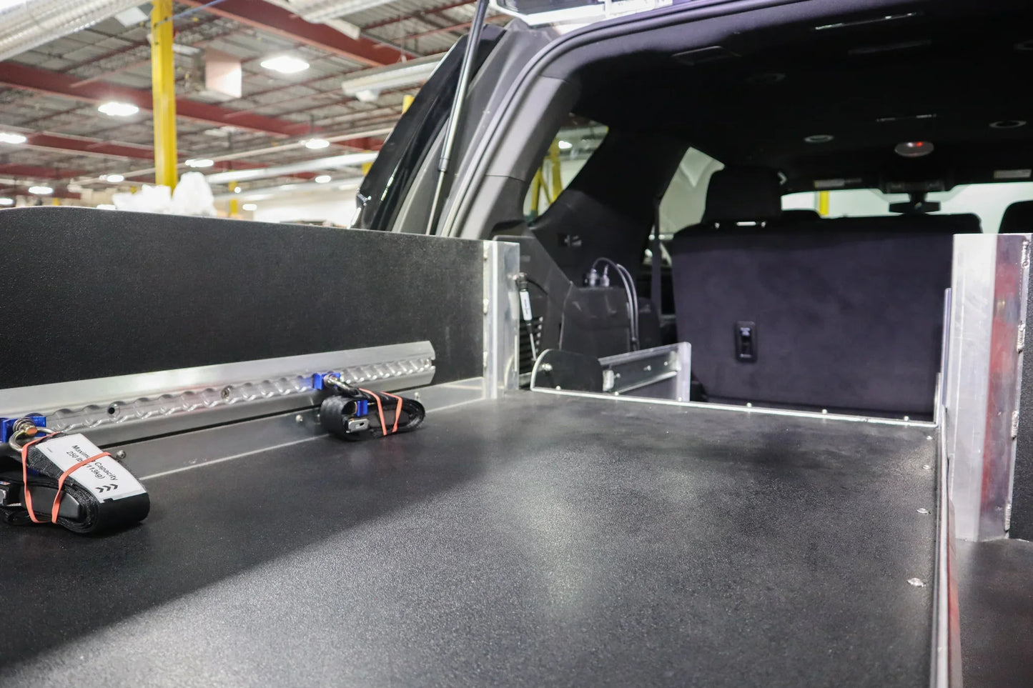 Rear storage system in a Chevrolet Tahoe emergency vehicle with fold-able stretcher insert.