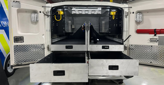 SpaceKap rear storage system with two drawers and two L drawers on an emergency response truck, designed for organized equipment storage.