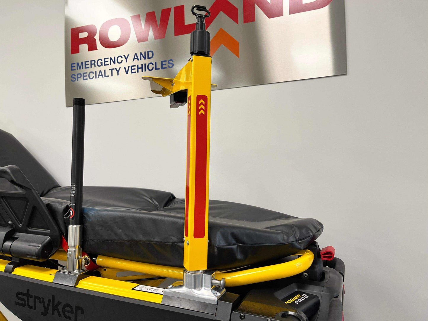 Defibrillator mounting block for Stryker® Power-PRO 2 (patient left) by Rowland Emergency, providing secure mounting and easy access to defibrillators during patient transport.