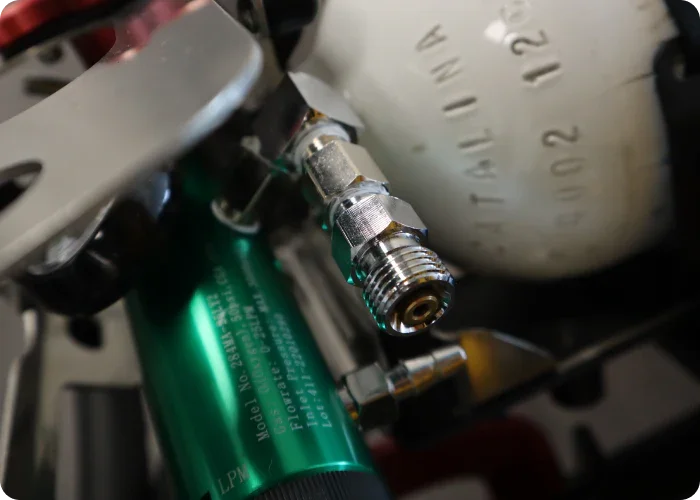 Oxygen tank fittings on the oxygen carry unit by Rowland Emergency, designed for secure and efficient transport of oxygen tanks.
