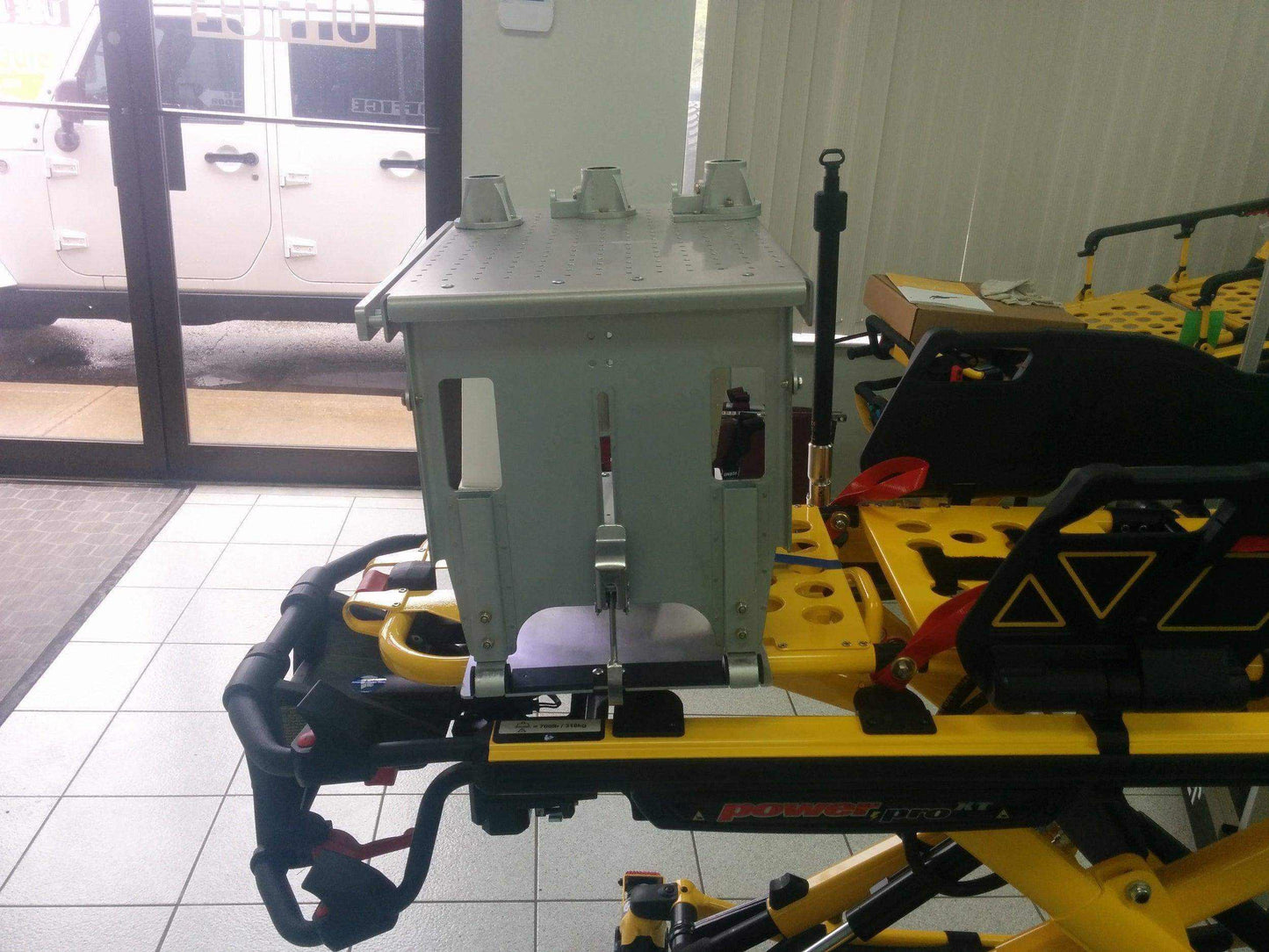 PacRac mount to Stryker® Power-PRO XT stretcher by Rowland Emergency, offering secure attachment and organized storage for medical equipment during patient transport.
