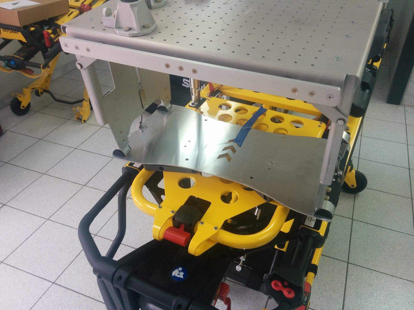PacRac mount to Stryker® Power-PRO XT stretcher by Rowland Emergency, offering secure attachment and organized storage for medical equipment during patient transport.