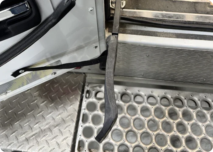 Top view of a Stryker Power-LOAD Flipper Extension for stretchers in an ambulance.