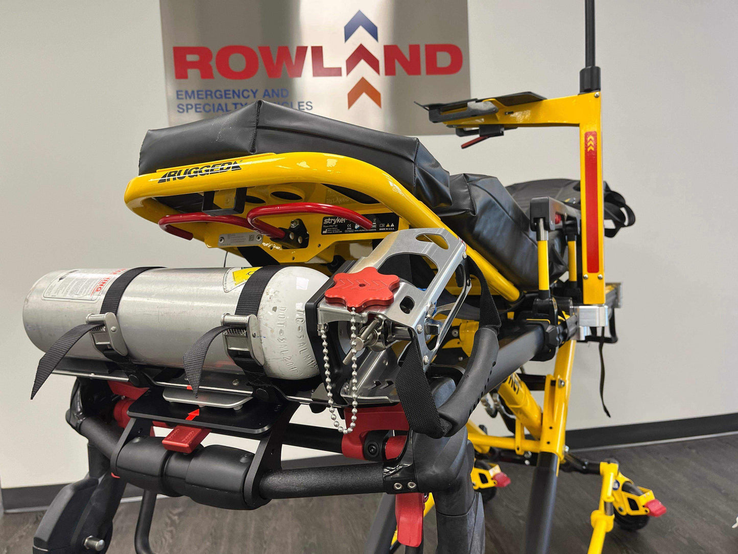 Stryker® Power-PRO XT & Power-PRO 2 cot-mounted oxygen carry kit by Rowland Emergency, designed for secure and accessible oxygen tank storage during patient transport.