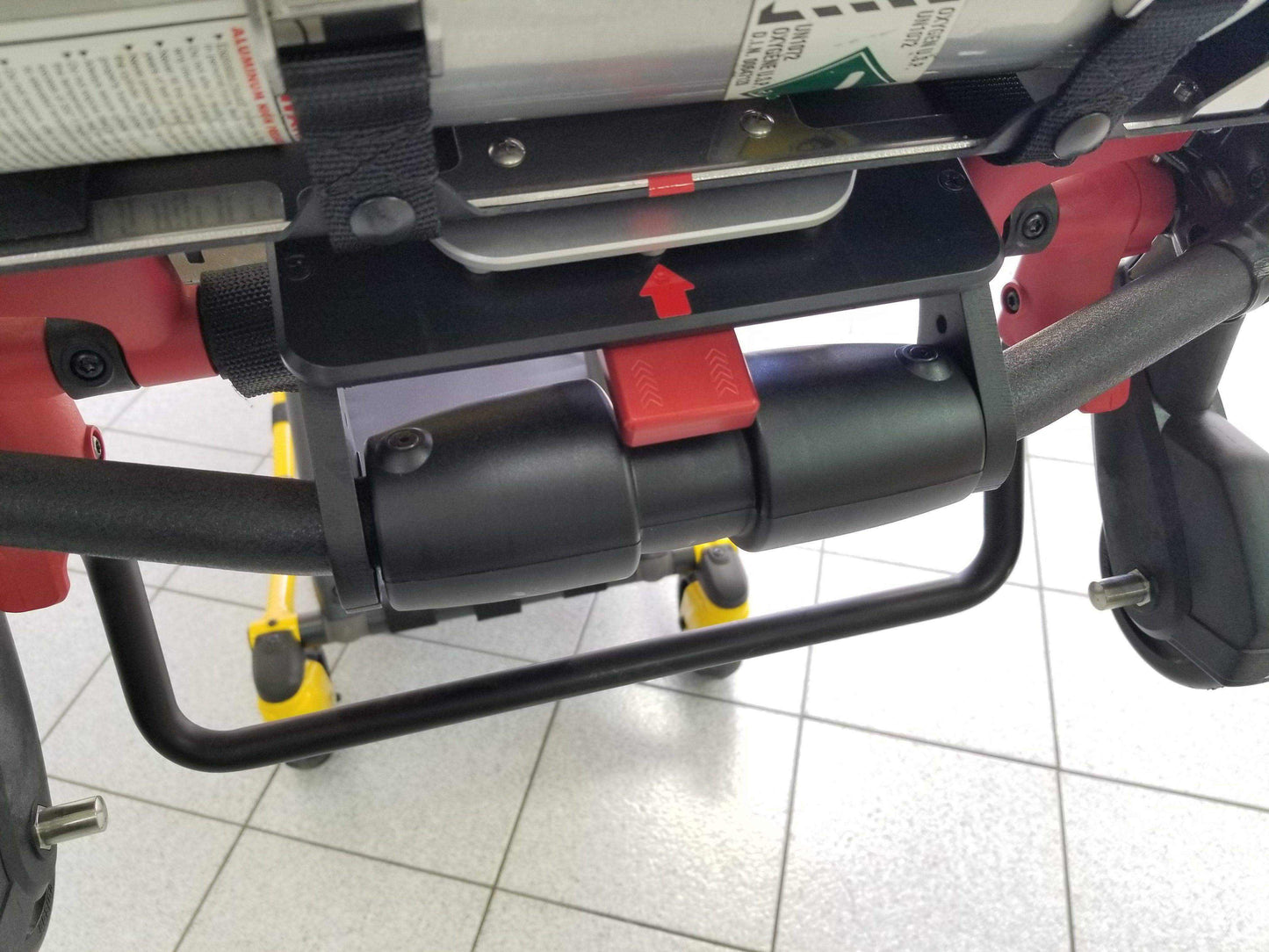 Stryker® Power-PRO XT & Power-PRO 2 cot-mounted oxygen carry kit by Rowland Emergency, designed for secure and accessible oxygen tank storage during patient transport.