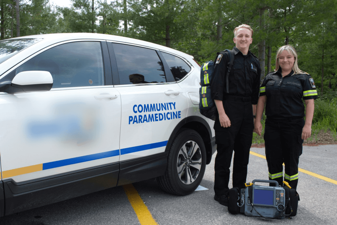 Community paramedicine team standing by medical vehicle with emergency equipment, Rowland Emergency