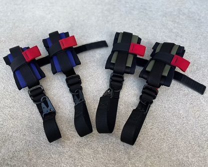 Set of four XDcuff (REF115C+) black straps with red and blue accents on a gray surface
