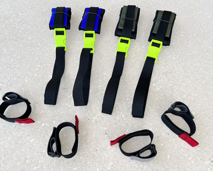 Set of XDcuff REF105 black straps with colorful clips on a concrete surface