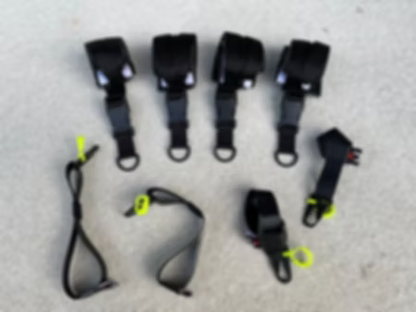 Set of XDcuff REF117 black straps with connectors on a light gray surface