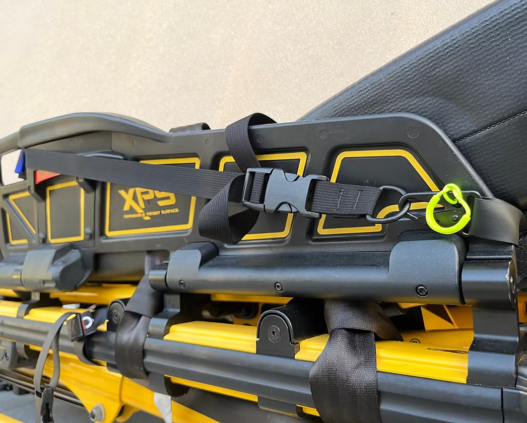 Close-up of a XPS side rail with an XDcuff REF117C strap and a yellow accent on a light background