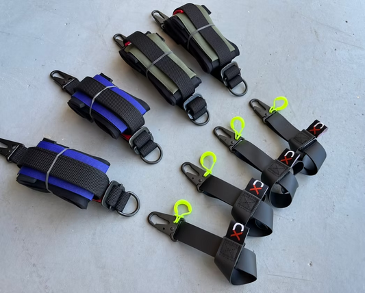 Set of XDcuff REF115C black straps with colorful accents on a light gray surface