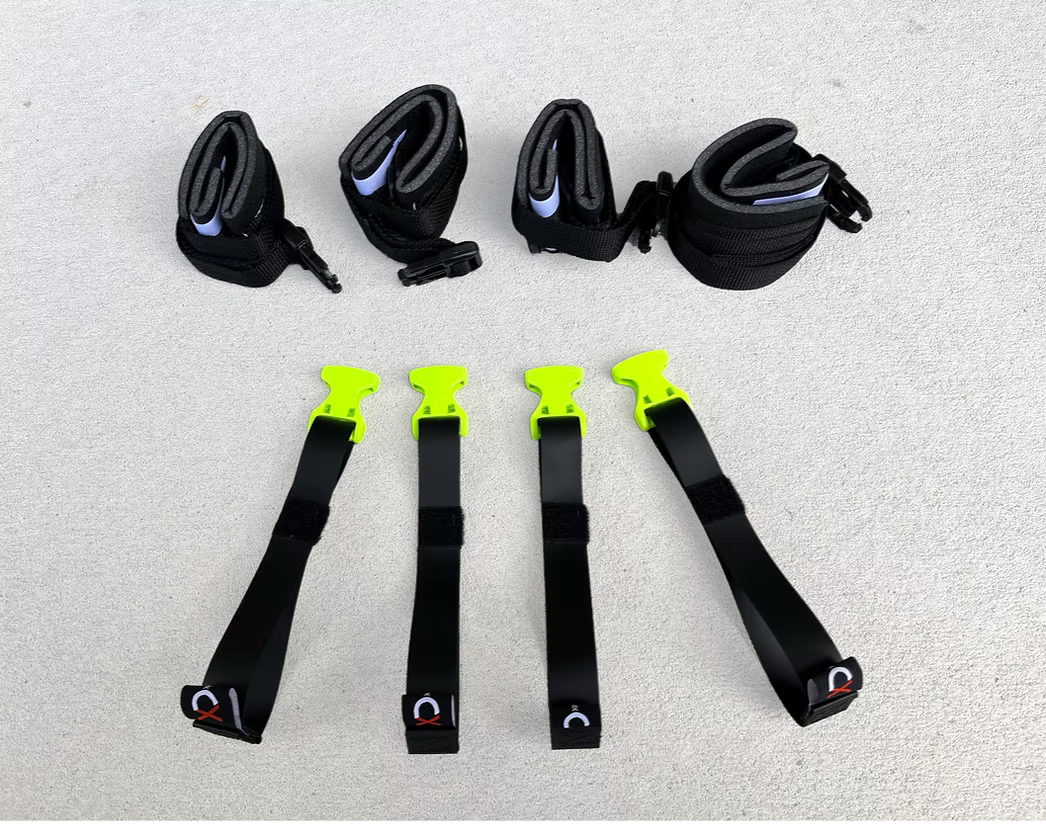 Set of black and yellow XDcuff REF117 disposable straps on a concrete surface