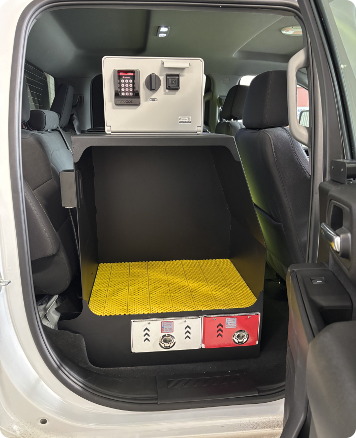 Custom EMS vehicle storage unit with secure safe, yellow mat, and supply compartments by Rowland Emergency