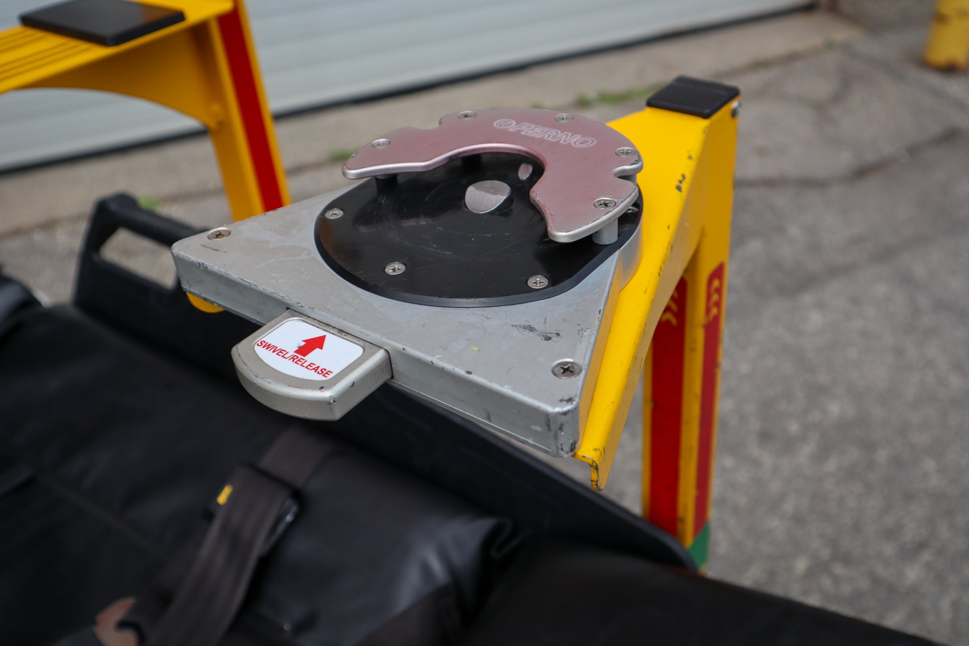 Close-up of a Ferno D360 mount on a Rowland Emergency pole with a blurred background.