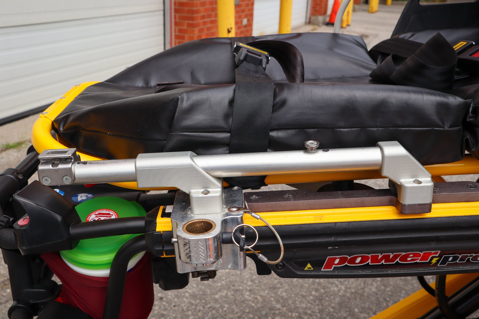Left-hand side of a Ferno PacRac+ adaptor rail by Rowland Emergency on a Stryker Power-PRO XT stretcher.
