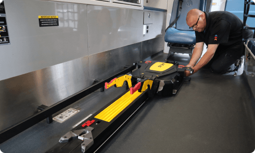 A Stryker-trained technician installing a Stryker Power-LOAD system into an ambulance.
