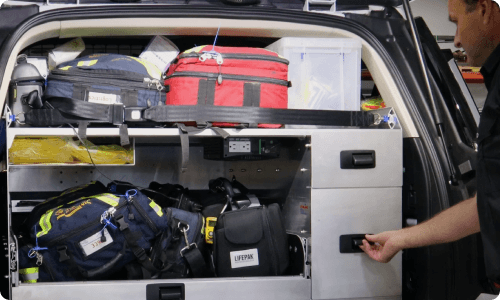 Paramedic accessing Rowland Emergency rear storage solution.